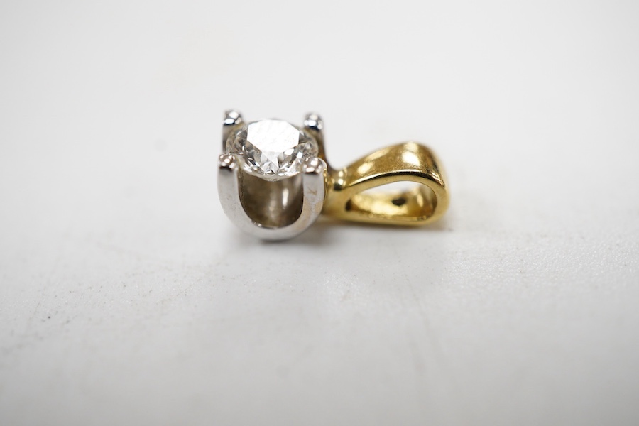 A recent 18ct two colour gold and solitaire diamond set pendant, the stone weighing approx. 0.20ct.